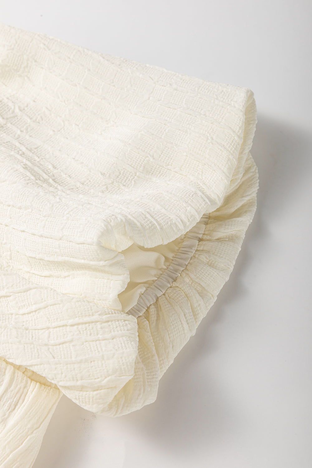 White Textured Bow Ties Front Bubble Hem Puff Short Sleeve Blouse